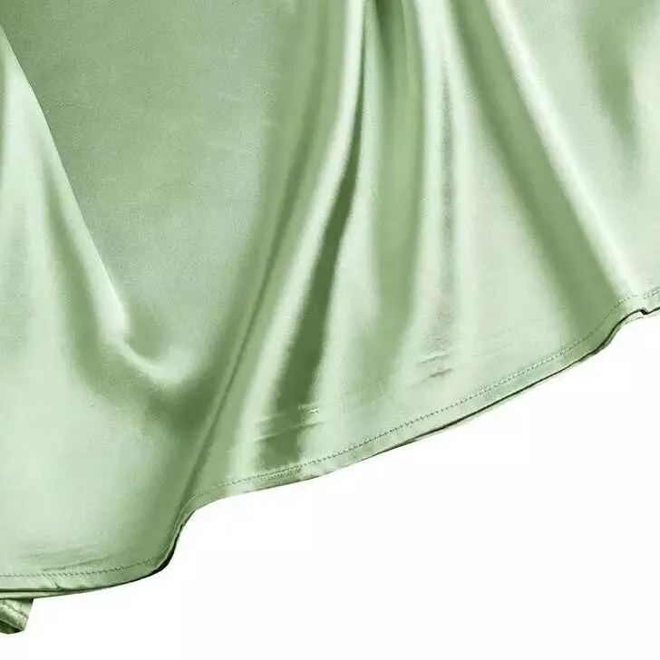 Sage green short-sleeved, knotted satin blouse